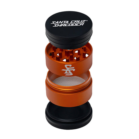 Orange-and-black Santa Cruz Shredder Split Tone grinder with separated components, shown as one design example.