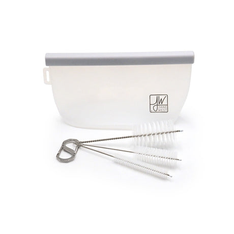 A Jane West cleaning bag beside three brushes joined to a metal carabiner, shown as one kit example.